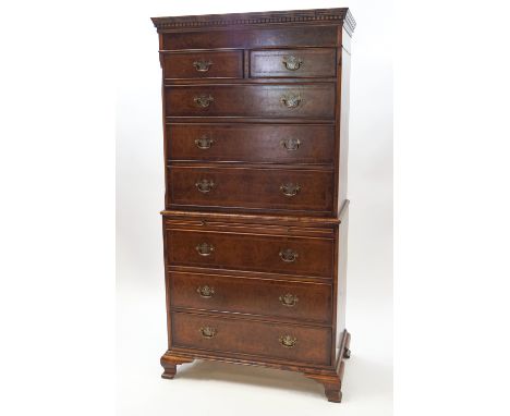 A 20th century walnut chest on chest, dentil cornice over eight drawers with herringbone inlay and brushing slide, on ogee br