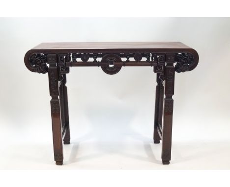 A 20th century Chinese hardwood alter table with scroll ends and carved detail, 84.5cm high x 116cm wide x 41cm deep