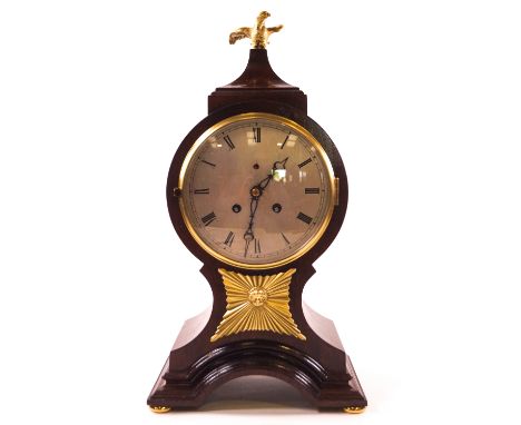 A 19th century mahogany balloon shaped mantel clock, the eight day movement with bell strike, the case surmounted by a gilt m