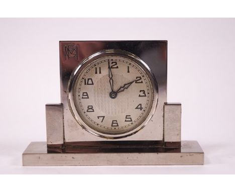 An Art Deco chrome bedside clock, monogrammed FGM, 7cm high x 10cm wide