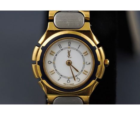 An Yves Saint Laurent ladies stainless steel and gilt bracelet watch, circa 1988, white dial with black Arabic and raised gil