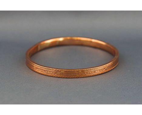 A hallmarked 9ct rose gold large hollow slave bangle. (Dented) 10.3 grams