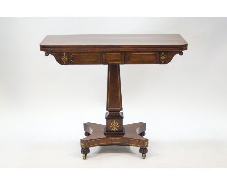 A late Regency rosewood card table with brass inlay, on gadrooned obelisk column and quatre form base, 75cm high x 91cm wide 