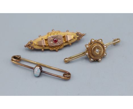 A 9ct gold bar brooch with a central Ruby surrounded by Diamonds together with another bar brooch with central Diamond and an