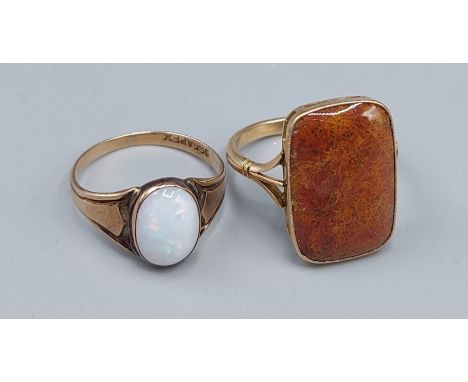 A yellow metal goldstone set ring, 4gms, ring size Q together with a 9ct gold Opal set ring, 2gms, ring size O