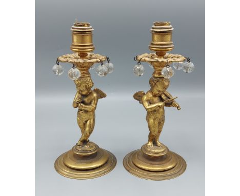 A pair of French gilded candlestick lustres in the form of Putti, 20cms tall