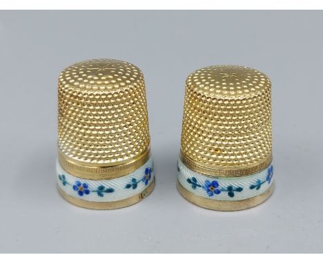 A pair of Austrian silver gilt and enamel decorated thimbles, early 20th Century