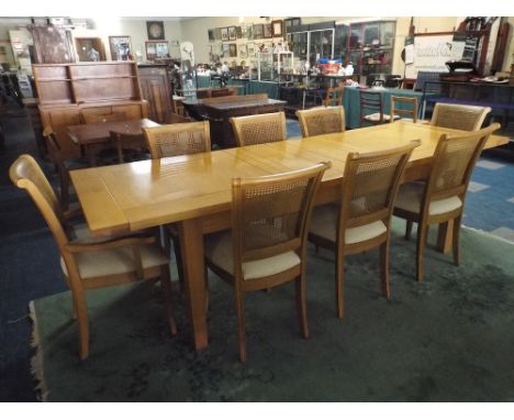 A Good Quality Light Oak Rectangular Dining Table and Eight Cane Backed Chairs with Upholstered Seats, Table 270x92cm