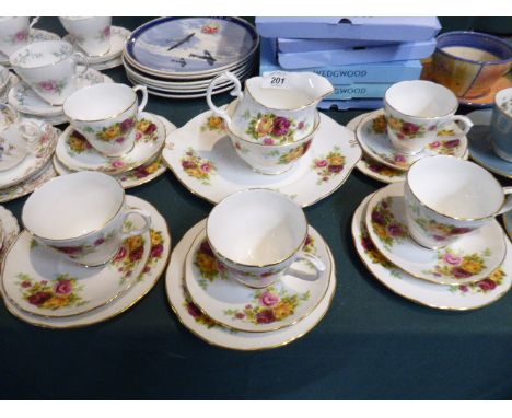 A Rose Pattern Part Tea Service Comprising Five Trios, Cake Plate, Sugar Bowl and Cream Jug