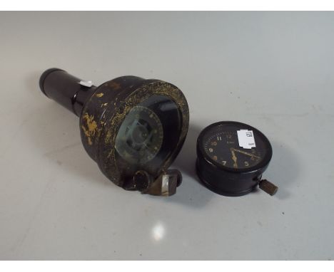 A Vintage Hand Held Dampened Compass and a Eight Day Military Clock