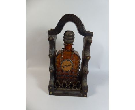 A Wooden Single Bottle Tantalus with Amber Glass Decanter and Whisky Label