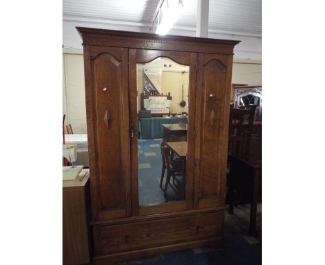 An Edwardian Oak Double Wardrobe with Mirrored Door and Base Drawer