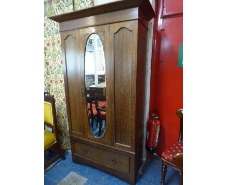 A Late Victorian Oak Wardrobe with Base Drawer and Mirror Door