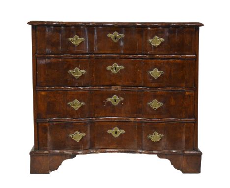 German elm and aok veneered serpentine commode, eighteenth century, broad crossbanding throughout, the top with moulded edge,