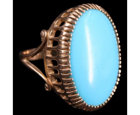 A near contemporary turquoise and 9 ct gold cocktail ring, having a large oval cabochon of approx 19 mm x 25 mm claw-set on a