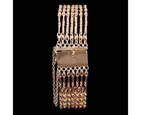 A vintage 9 ct gold multi-strand bracelet, comprising seven double fetter link chains with broad box clasp and safety chain, 