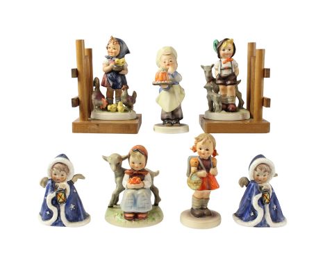 A pair of Goebel Hummel bookends together with a pair of blue cloaked angels with lanterns and three other Hummel figurines