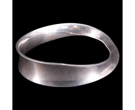 A Georg Jensen "Möbius" white metal bangle, designed by Vivianna Torun Bülow-Hübe, numbered 206, internal dimensions 70 mm x 