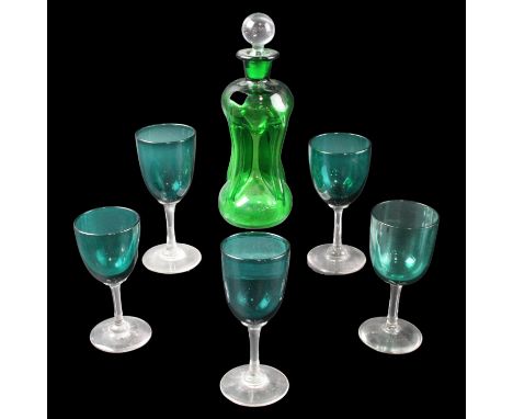 An emerald glass kutrolf liqueur decanter with five glasses