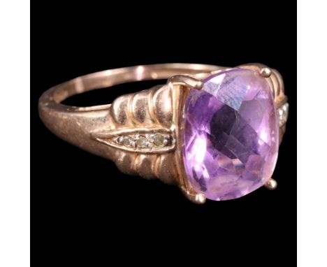 A near contemporary amethyst, diamond and 9 ct gold dress ring, comprising a central oblong checkerboard-cut stone of approx 