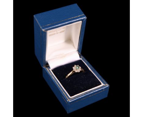A near contemporary emerald, diamond and 18 ct gold flowerhead cluster ring, comprising round-cut stones claw-set between the