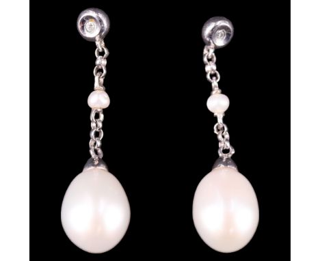 A pair of contemporary diamond, pearl and 9 ct white gold ear pendants, largest pearl 7 mm x 9 mm, drop 29 mm, 2.4 g