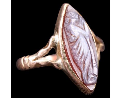 A late 19th / early 20th Century Neo-Classical cameo finger ring, the navette cameo depicting a Classical female, bezel-set b