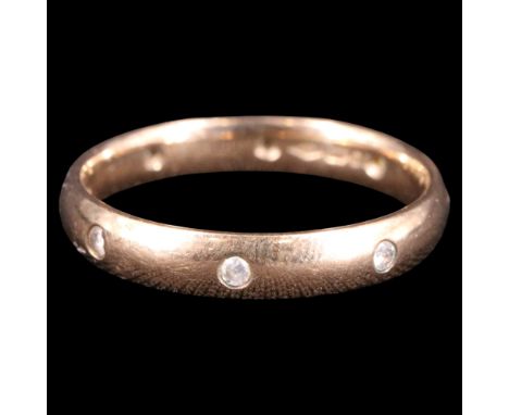 A contemporary diamond and 9 ct gold band, the ring flush-set with eight brilliants of approx 0.08 ct aggregate weight, O, 2.