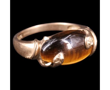A contemporary tiger's eye and 9 ct gold double serpent ring, comprising an oval cabochon set between the tapering serpent-en
