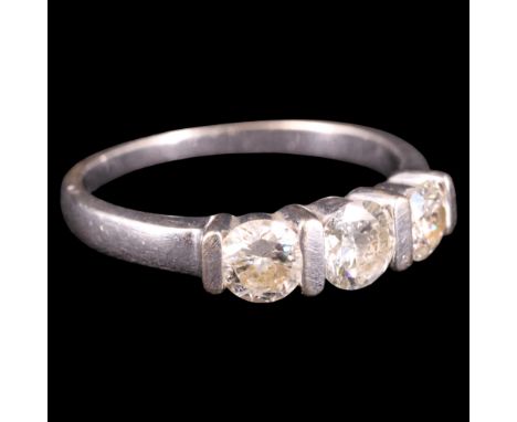 A contemporary three-stone diamond and 18 ct gold ring, comprising three subtly graded brilliants of approx 0.85 ct aggregate