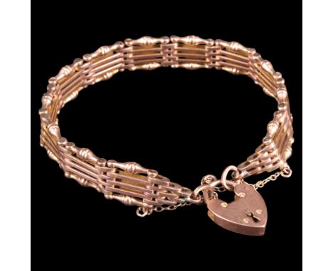 A late 19th / early 20th Century 9 ct rose gold gate-link bracelet, edged with addorsed-bell and cushion-knop links, having a