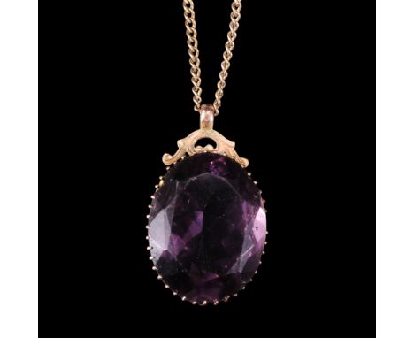 A vintage 9 ct yellow metal mounted amethyst-paste pendant and 9 ct yellow metal curb link neck chain, paste 28 mm x 22 mm, c
