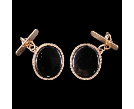 A pair of 1980s black onyx and 9 ct gold oval cufflinks, each matrix set within a dentil bezel, 13 mm x 11 mm, 3.4 g 