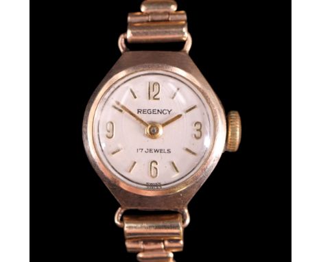 A 1960s lady's Regency 9 ct gold wristlet watch, having a 17-jewel movement and a tonneau-shaped case, on an open annuli-and-