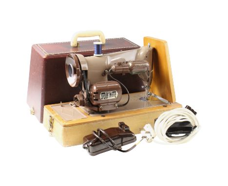 A vintage electric Singer sewing machine together with accessories 