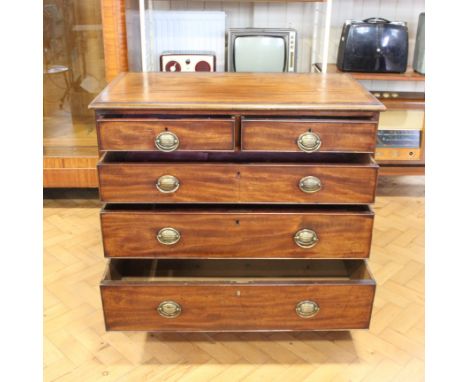 A George III mahogany chest of drawers having brass stamped backplate bale handles and square bracket feet, 94 cm x 53 cm x 8