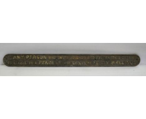 A cast iron railway gate sign detailing a forty shilling penalty for failure to shut and fasten the gate. Corroded surface. M