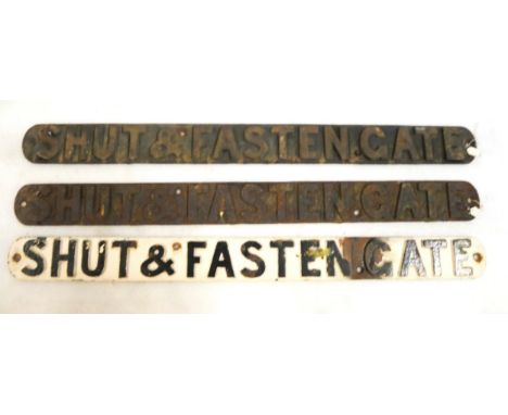 Three cast iron railway signs SHUT AND FASTEN THE GATE, Two with labels detailing the location from which they were removed. 