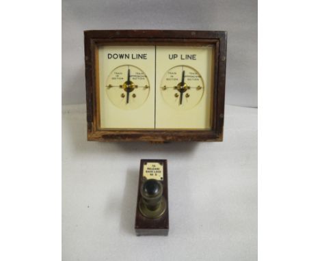 A double line block instrument in wooden case with side-by-side DOWN LINE and UP LINE indicators and a wood and brass push-bu