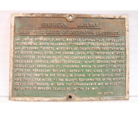 A cast iron railway sign from the Southern Railway warning to users of occupation crossings, informing them that permission m