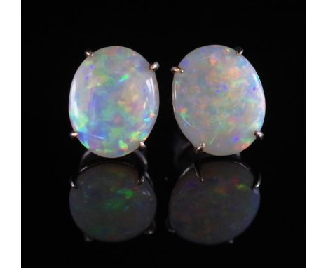 A pair of white opal and 14ct white gold earrings with stud and butterfly backs marked 585. Approx 10mm x 8mm cabochons