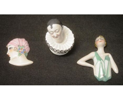 Two German porcelain flat half doll heads together with a German Pierrot pin cushion head