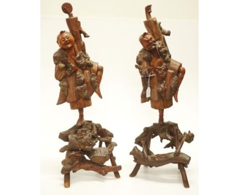 Vintage pair Chinese carved wood figures each depicting a figure in a tree, on figural naturalistic wood form bases, (small l