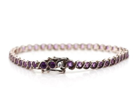 Amethyst set sterling silver tennis bracelet marked 925. Approx length 18cm