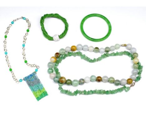 A group of semi precious gemstone jewellery includes a bangle, and treated jade bead and other beaded necklaces.
