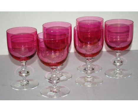 Set of six ruby glass red wine goblets with clear glass stems, height 16.5cm approx