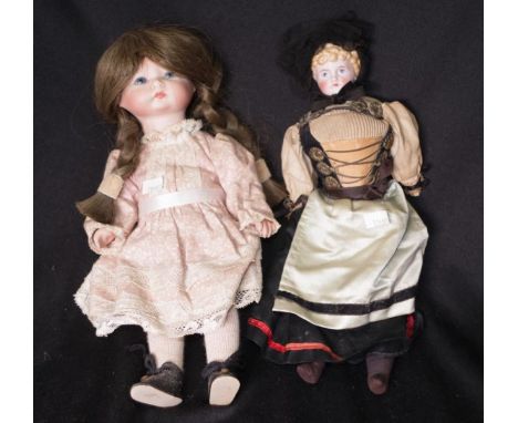 Two various vintage bisque dolls both in original clothing, height 31cm approx