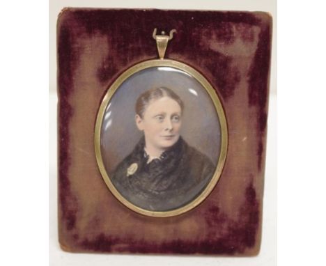 Victorian hand painted portrait miniature in brass frame mounted on a velvet stand, 12cm x 10cm approx