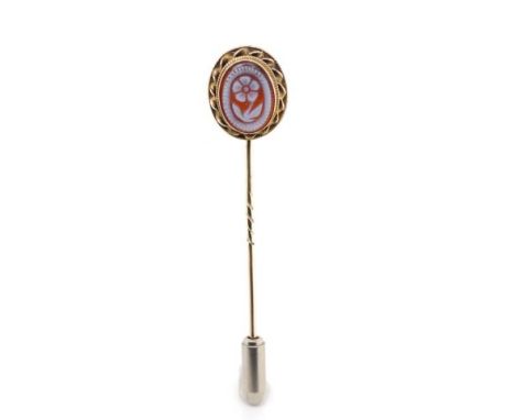 A well carved carnelian set gold stick pin unmarked. Approx 1.7 grams weight,