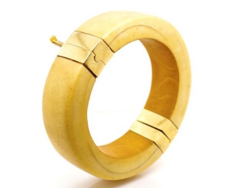 Mid century Ivory and gold bangle marked 18k to ends. With hinge and pin clasp. Approx inside diameter 58mm. This item may no